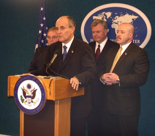 Rudy Guiliani at NYFPC briefing on "New York City - 1 Year After 9/11". Along beside him at the podium were Guiliani Partners colleagues New York City's former Police Commissioner Bernard Kerik, former Fire Commissioner Thomas Von Essen and former Director of the Office of Emergency Management Richard Sheirer.  http://fpc.state.gov/fpc/13404.htm.  September 10, 2002.  U.S. Department of State.  This work is in the public domain in the United States because it is a work of the United States Federal Government under the terms of Title 17, Chapter 1, Section 105 of the US Code. See Copyright.